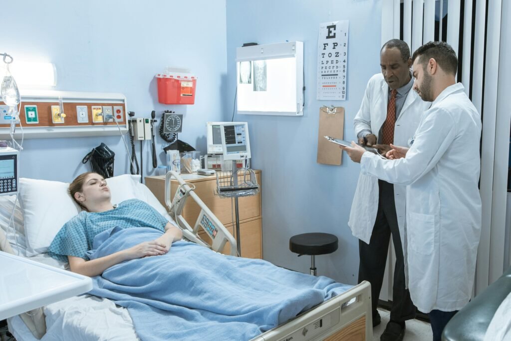 Medical professionals consulting over a patient's treatment in a hospital setting.